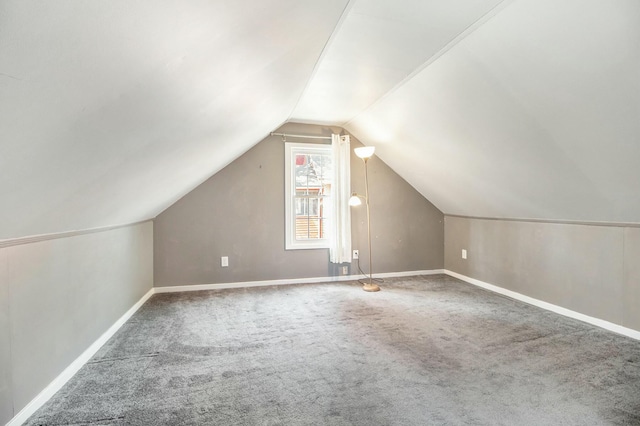 bonus room with vaulted ceiling, baseboards, and carpet floors