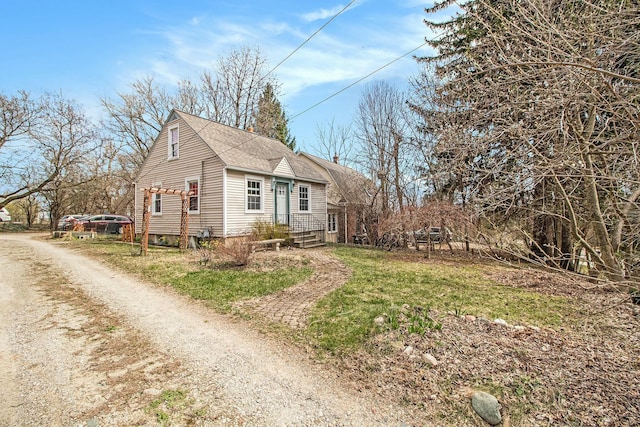 view of side of home featuring roof with shingles