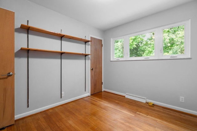 3091 Warwick Rd, Ann Arbor, MI 48104 - unfurnished bedroom with baseboards, wood finished floors, and visible vents