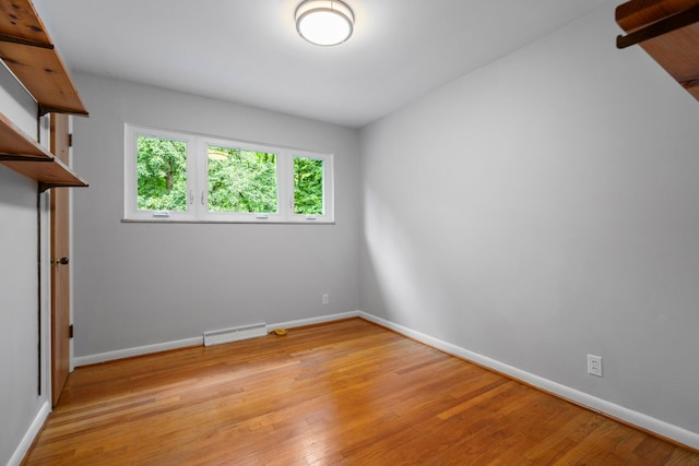 3091 Warwick Rd, Ann Arbor, MI 48104 - spare room featuring baseboard heating, baseboards, and light wood-type flooring