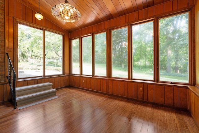 3091 Warwick Rd, Ann Arbor, MI 48104 - unfurnished sunroom featuring wooden walls, hardwood / wood-style floors, a wealth of natural light, and vaulted ceiling