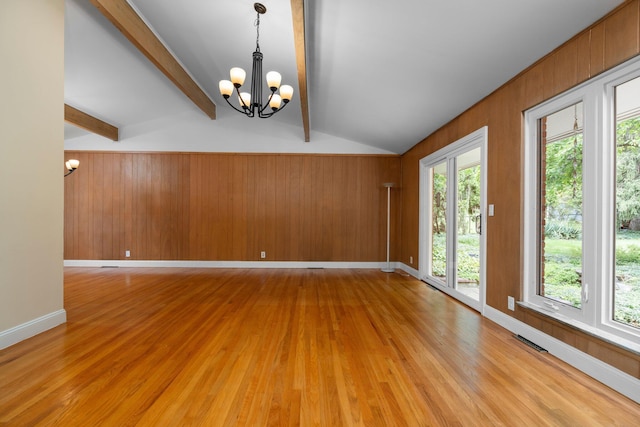 3091 Warwick Rd, Ann Arbor, MI 48104 - unfurnished room featuring light wood-style flooring, vaulted ceiling with beams, visible vents, a chandelier, and wood walls
