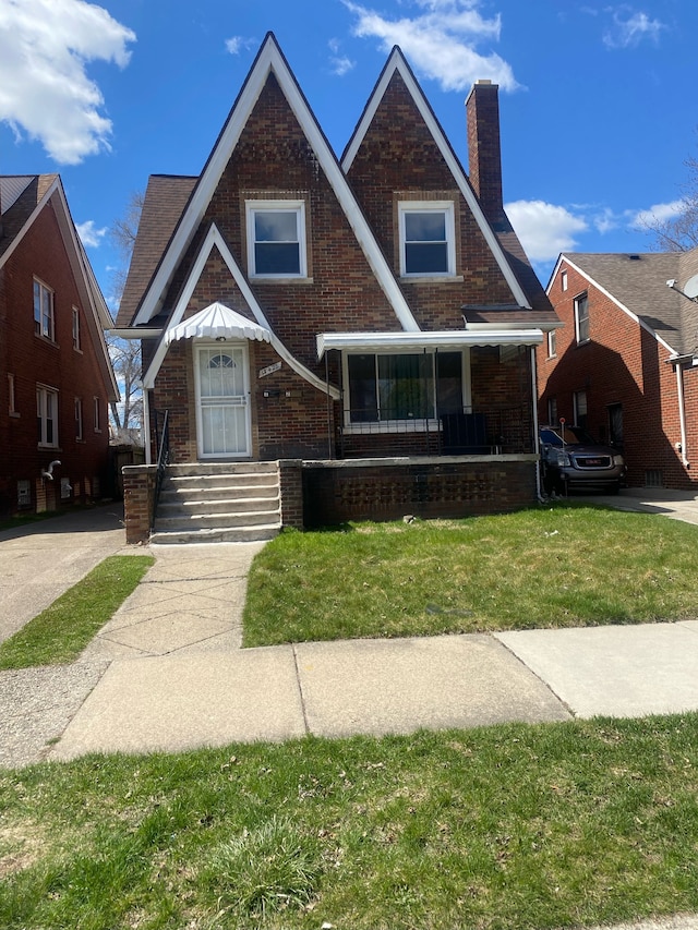15425 Sorrento St, Detroit, MI 48227 - english style home with brick siding, a chimney, and a front yard