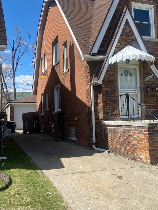 15425 Sorrento St, Detroit, MI 48227 - view of side of home featuring brick siding and roof with shingles