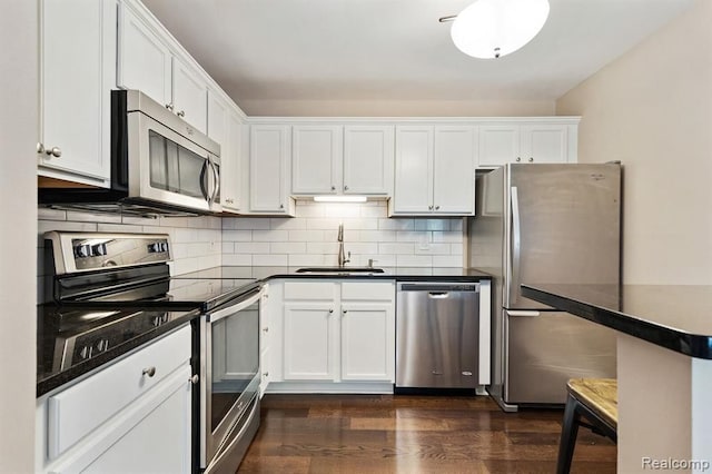 500 Romeo Rd Unit 116, Rochester, MI 48307 - kitchen featuring a sink, stainless steel appliances, white cabinetry, and dark countertops