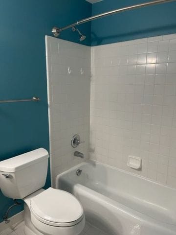 500 Romeo Rd Unit 116, Rochester, MI 48307 - bathroom featuring toilet, bathing tub / shower combination, and tile patterned flooring