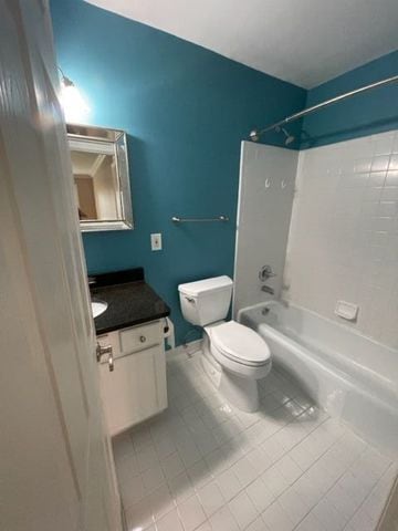 500 Romeo Rd Unit 116, Rochester, MI 48307 - full bathroom with tile patterned floors, toilet, vanity, and shower / washtub combination