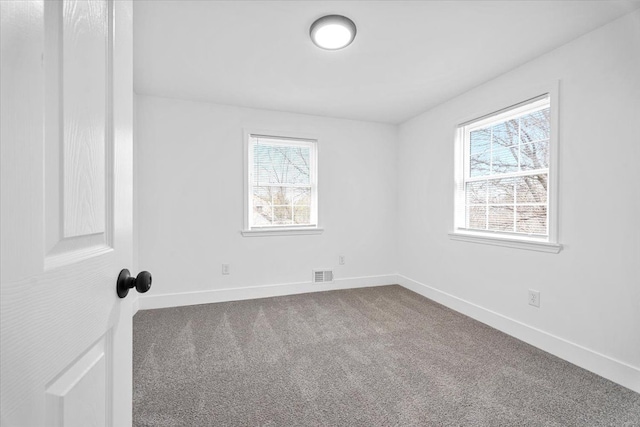 carpeted empty room with baseboards and visible vents
