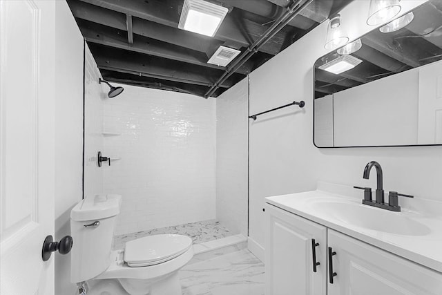 bathroom with a stall shower, vanity, marble finish floor, toilet, and visible vents