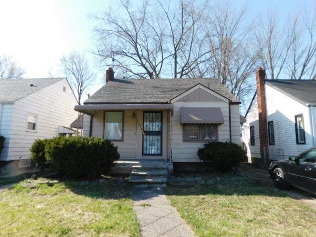 15864 Bringard Dr, Detroit, MI 48205 - bungalow-style house featuring a chimney and a front lawn