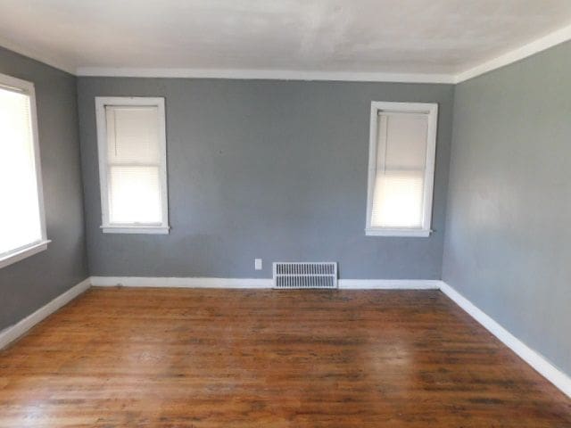 15864 Bringard Dr, Detroit, MI 48205 - spare room with ornamental molding, wood finished floors, visible vents, and plenty of natural light