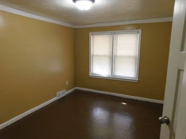 15864 Bringard Dr, Detroit, MI 48205 - unfurnished room featuring visible vents, baseboards, and ornamental molding