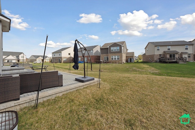 view of yard featuring a wooden deck, a residential view, and cooling unit