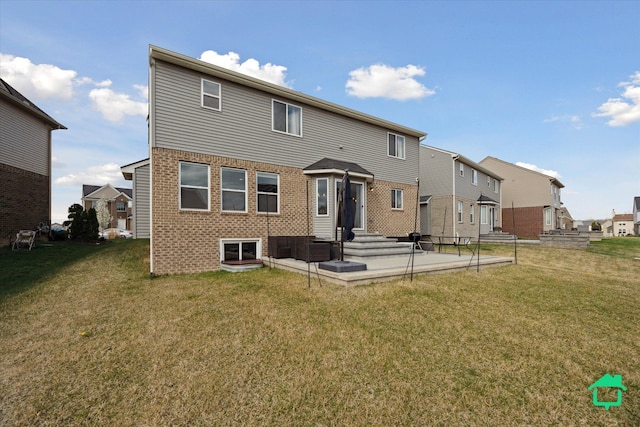 rear view of property with a lawn, brick siding, and a residential view