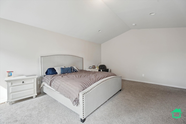 carpeted bedroom featuring vaulted ceiling and baseboards