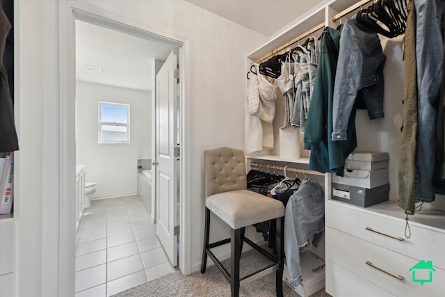 spacious closet with light tile patterned floors