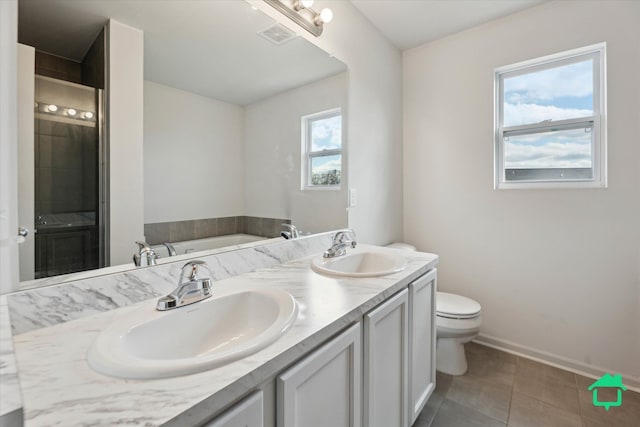 bathroom with double vanity, tile patterned flooring, toilet, and a sink