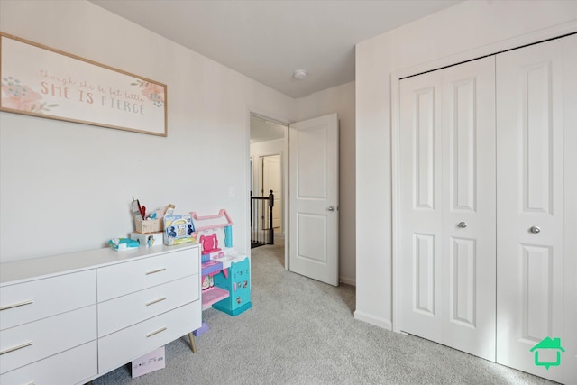 bedroom featuring a closet and light colored carpet