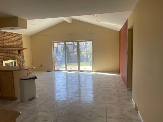 unfurnished living room featuring lofted ceiling with beams and a fireplace
