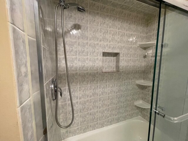 bathroom with a shower with door
