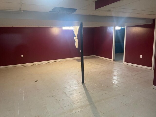 finished basement featuring tile patterned floors and baseboards