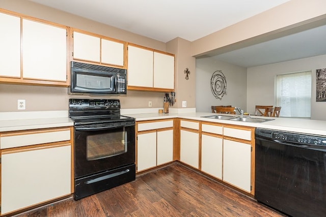 6472 Lochaven Ln, Waterford, MI 48327 - kitchen featuring black appliances, a sink, light countertops, dark wood-type flooring, and white cabinetry