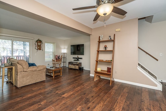 6472 Lochaven Ln, Waterford, MI 48327 - living area with dark wood finished floors, a ceiling fan, stairs, and baseboards