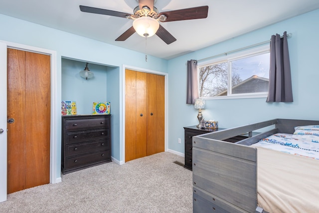 carpeted bedroom with baseboards and a ceiling fan