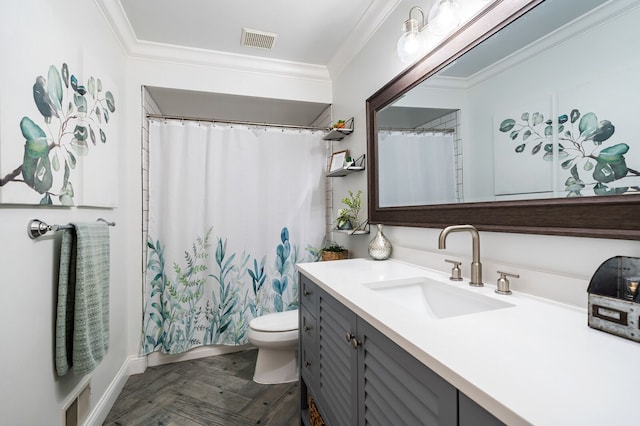 bathroom featuring toilet, ornamental molding, vanity, and visible vents