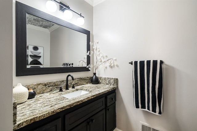 bathroom featuring crown molding, vanity, and visible vents