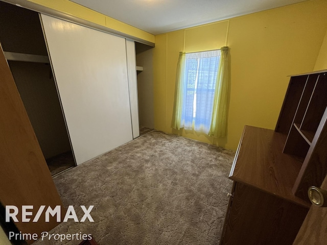 unfurnished bedroom featuring a closet and carpet floors