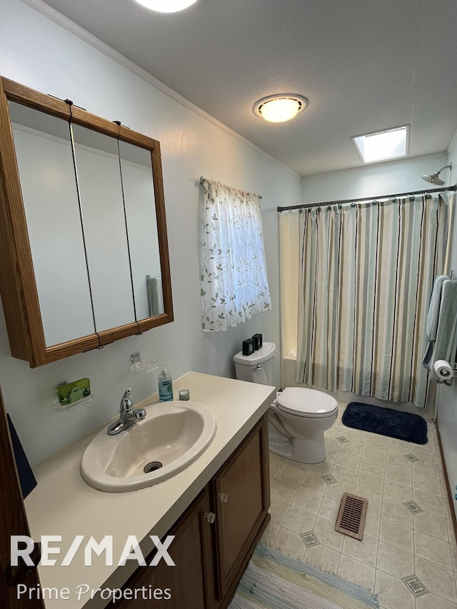full bath with shower / tub combo with curtain, toilet, ornamental molding, tile patterned floors, and vanity