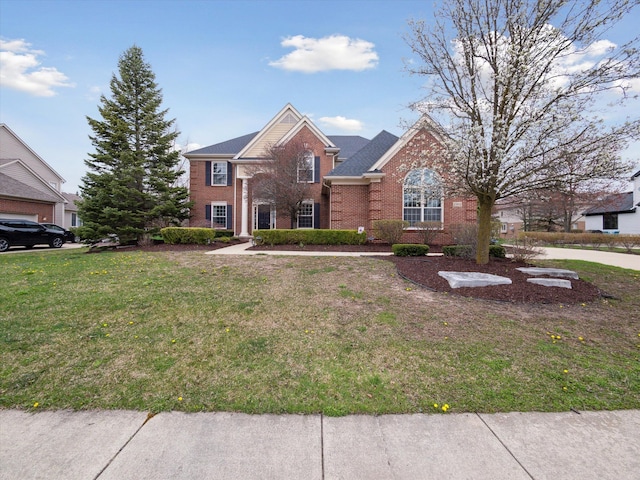 view of front facade featuring a front lawn and brick siding