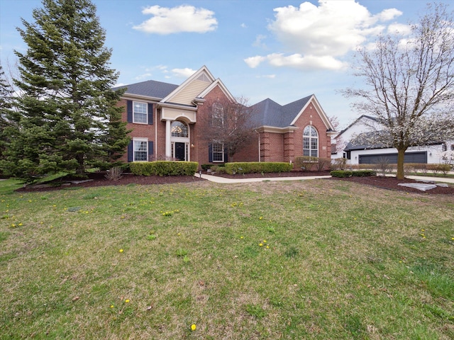 view of front of house with a front lawn and brick siding