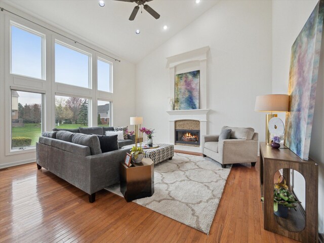 living area featuring high vaulted ceiling, recessed lighting, ceiling fan, and wood-type flooring
