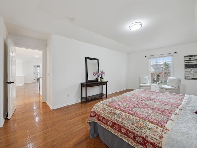 bedroom featuring baseboards and light wood-type flooring