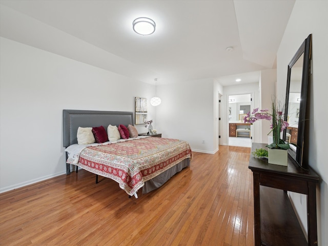 bedroom featuring baseboards, light wood finished floors, and recessed lighting