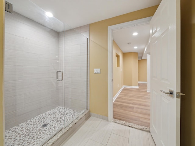 full bathroom featuring recessed lighting, baseboards, tile patterned flooring, and a stall shower