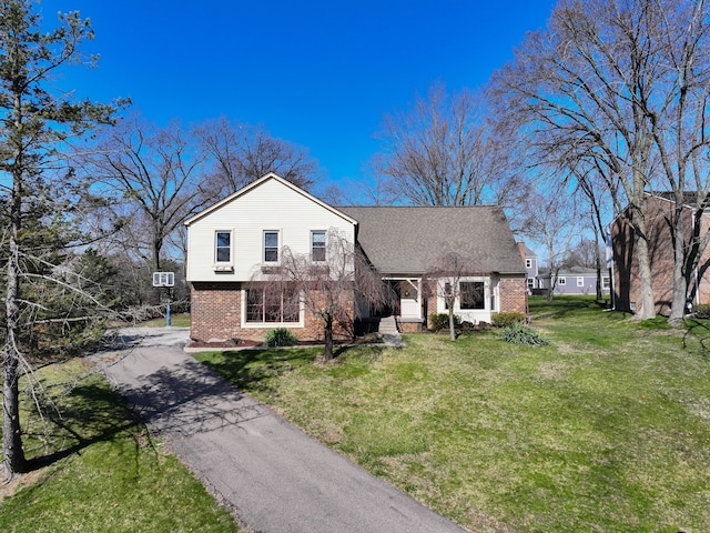 4238 Still Meadow Ln, West Bloomfield, MI 48323 - rear view of property with brick siding, asphalt driveway, and a lawn