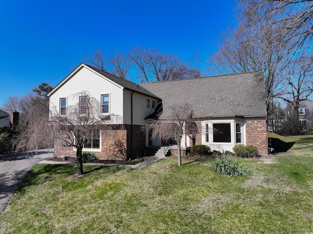 4238 Still Meadow Ln, West Bloomfield, MI 48323 - view of front of home with brick siding, a front yard, and a shingled roof