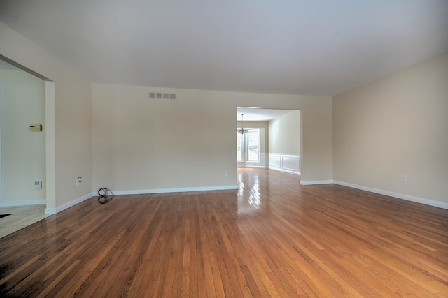 4238 Still Meadow Ln, West Bloomfield, MI 48323 - empty room with wood-type flooring, a chandelier, and baseboards
