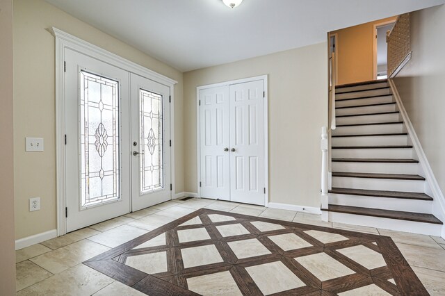 4238 Still Meadow Ln, West Bloomfield, MI 48323 - foyer entrance featuring baseboards, french doors, inlaid floor details, stairs, and plenty of natural light