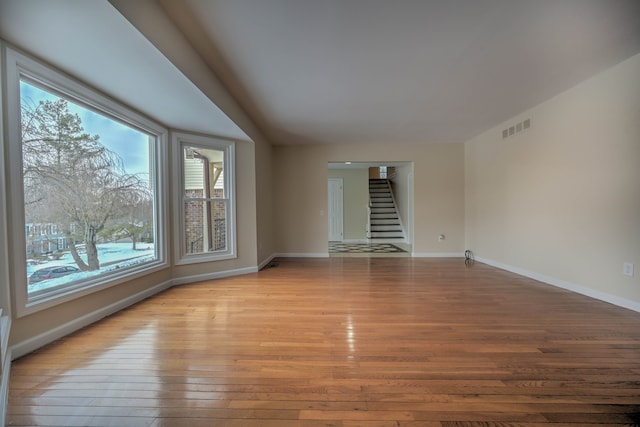 4238 Still Meadow Ln, West Bloomfield, MI 48323 - empty room with hardwood / wood-style floors, stairs, and healthy amount of natural light