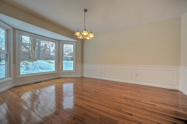 4238 Still Meadow Ln, West Bloomfield, MI 48323 - unfurnished room featuring a chandelier, hardwood / wood-style floors, and a wainscoted wall