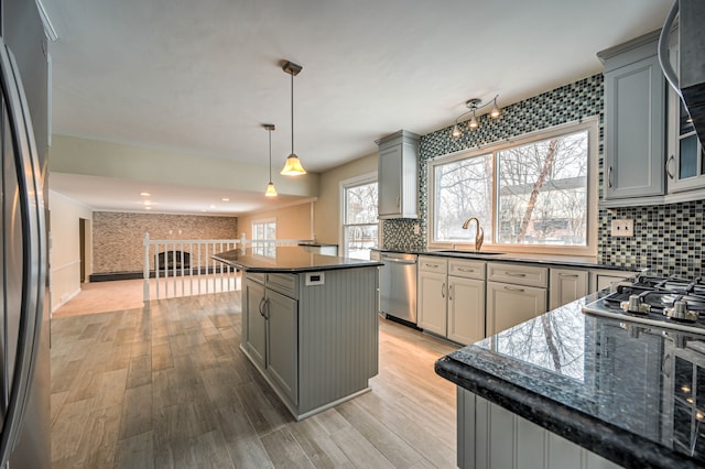 4238 Still Meadow Ln, West Bloomfield, MI 48323 - kitchen featuring stainless steel appliances, a sink, gray cabinets, backsplash, and light wood finished floors