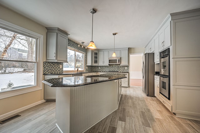 4238 Still Meadow Ln, West Bloomfield, MI 48323 - kitchen featuring appliances with stainless steel finishes, gray cabinetry, light wood-type flooring, and backsplash