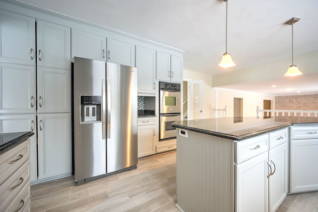 4238 Still Meadow Ln, West Bloomfield, MI 48323 - kitchen with stainless steel appliances, backsplash, decorative light fixtures, dark stone counters, and light wood-type flooring