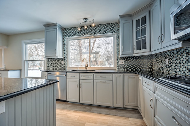4238 Still Meadow Ln, West Bloomfield, MI 48323 - kitchen featuring a sink, appliances with stainless steel finishes, tasteful backsplash, glass insert cabinets, and light wood-type flooring