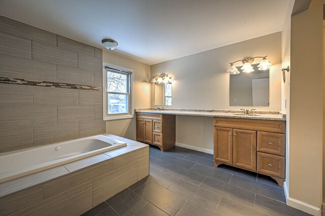 4238 Still Meadow Ln, West Bloomfield, MI 48323 - bathroom with a relaxing tiled tub, double vanity, tile patterned flooring, and baseboards