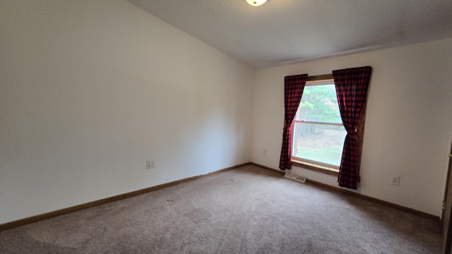 carpeted empty room with baseboards and visible vents